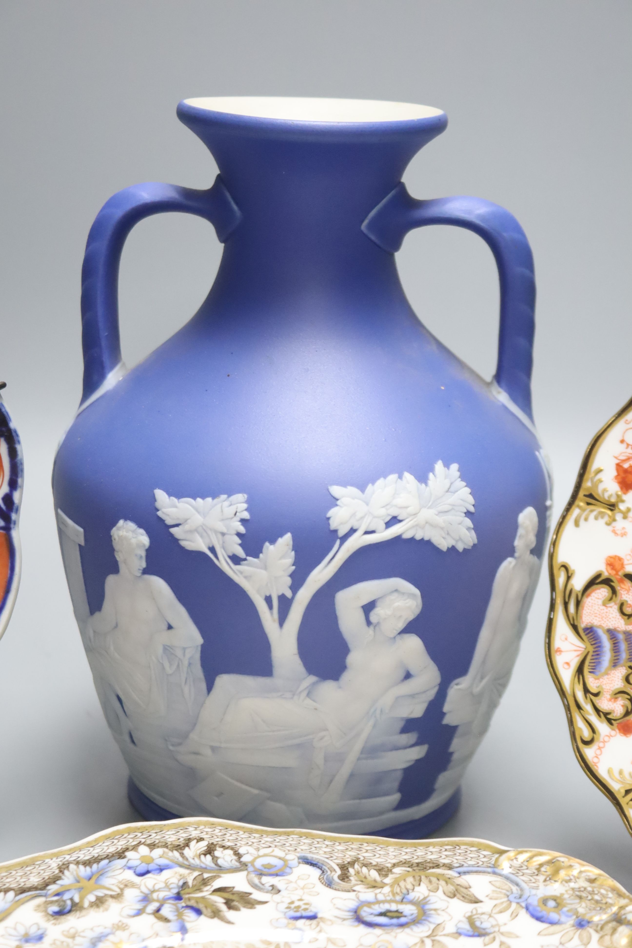 A Wedgwood jasperware Portland vase, 19th century, height 21cm, and four Victorian plates to include Spode and Royal Crown Derby